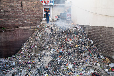 Burning rubbish pile at sunrise, Jodhpur, Rajasthan, India
