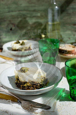 Black Lentil Charred Broccoli Shepherd's Pie served with bread and white wine.