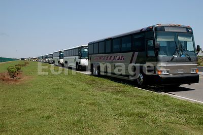 Charter buses wait to carry Katrina survivors to shelters