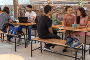 Customers sit and chat over coffee in the garden of Blue Tokai coffee in Champa Gali,