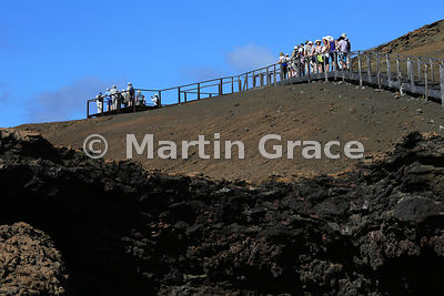 Two tourist groups on the boarded walk to the viewpoint summit of Bartolome Island, Galapagos Islands