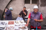 Stallholders at the Mercato della Pescheria Market wait for customers