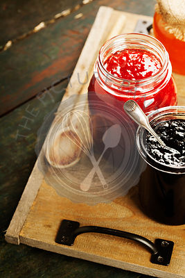 Fruit and berry jam with ingredients on a wooden background