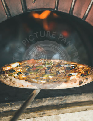Freshly baked pizza with vegetables in wood oven