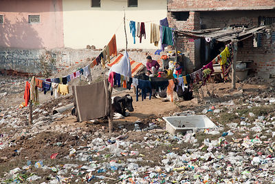 A person's back yard almost entirely consumed by plastic garbage, Delhi, India