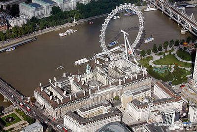 aerial photograph of London County Hall Westminster Bridge Rd London SE1 7JA England UK with the London Eye behind
