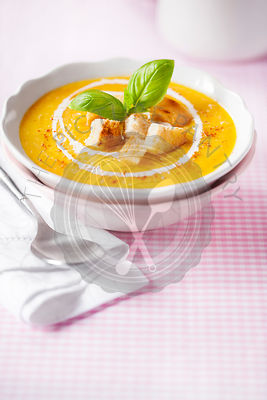 Pumpkin soup with croutons and basil