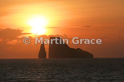 The sun setting behind Kicker Rock, Cerro Brujo, San Cristobal, Galapagos