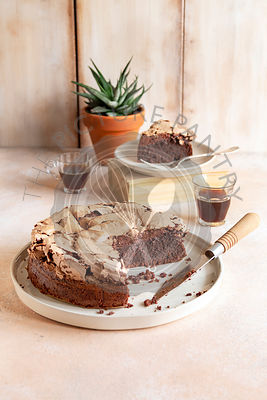 Brownie meringue cake and two cups of coffee on the table