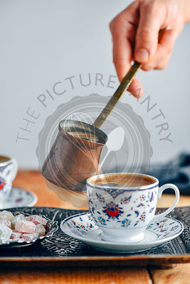 Turkish coffee served in a traditional Turkish coffee cup in a copper tray.