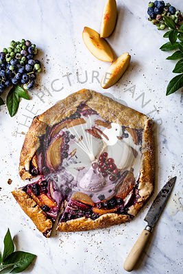 Peach and Blueberry Galette on a marble background