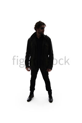 A Figurestock image of a mystery man standing and watching, in silhouette – shot from eye level.