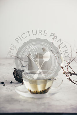 Tea composition with Cup of green tea and white teapot