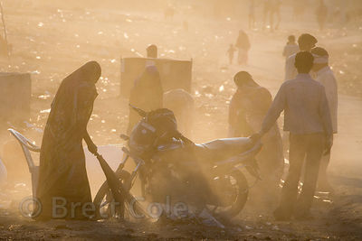 Women sweep up and burn garbage on a dusty desert road after the Pushkar Camel Fair, Pushkar, Rajasthan, India. Air pollution is an epidemic health crisis across India. India has the worst air pollution in the world, worse even than China, with Delhi the #1 worst city in the world.