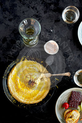 Roasted Cauliflower Citrus Pesto served in a black ceramic bowl. Photographed on a black/grey background.