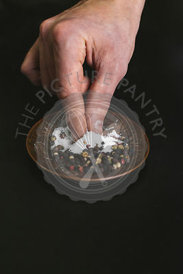 A man taking a pinch of salt