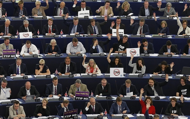 Members of the European Parliament take part in a voting session at the European Parliament in Strasbourg, France, June 10, 2015. The posters on the desks read "no TTIP". The European parliament decided on Tuesday to postpone the debate and the vote initially scheduled today on the E.U.-U.S. Transatlantic Trade and Investment Partnership (TTIP) talks. REUTERS/Vincent Kessler