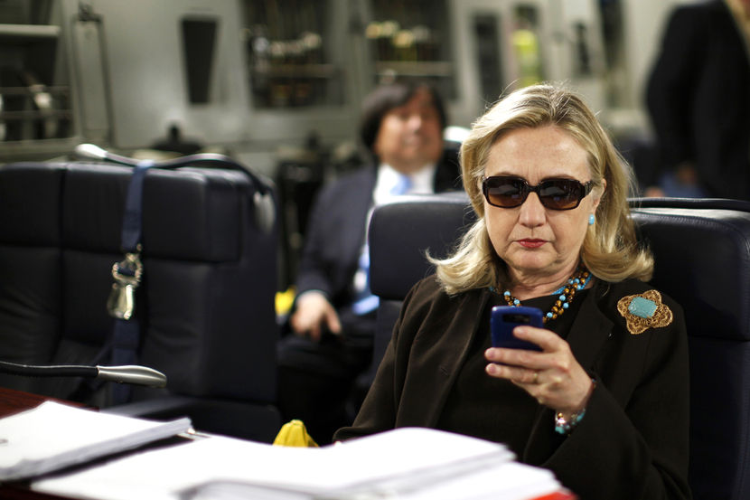 U.S. Secretary of State Hillary Clinton checks her PDA upon her departure in a military C-17 plane from Malta bound for Tripoli, Libya October 18, 2011. REUTERS/Kevin Lamarque (LIBYA - Tags: POLITICS) FOR BEST QUALITY IMAGE ALSO SEE: GF2EA1P10ZY01 - RTR2ST4W