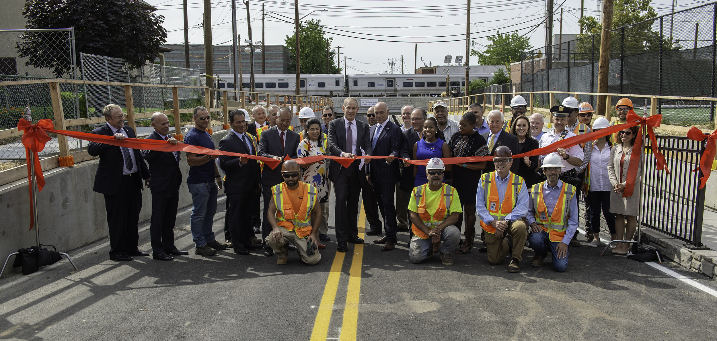 MTA Chief Development Officer Janno Lieber cuts the ribbon in a ceremony at Urban Avenue, marking the reopening of the roadway that now travels under the LIRR main line, the first of eight grade crossing eliminations to be completed as part of the $2.6 billion LIRR Expansion Project.