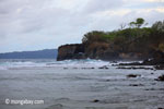 Waves breaking on the ocean-side coastline of Peucang Island