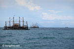 Traditional fishing boat with Krakatoa in the distance