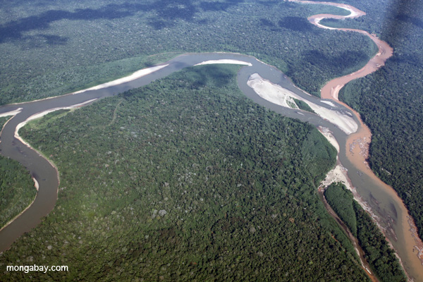 Polluted river merging with a pristine river in the Amazon