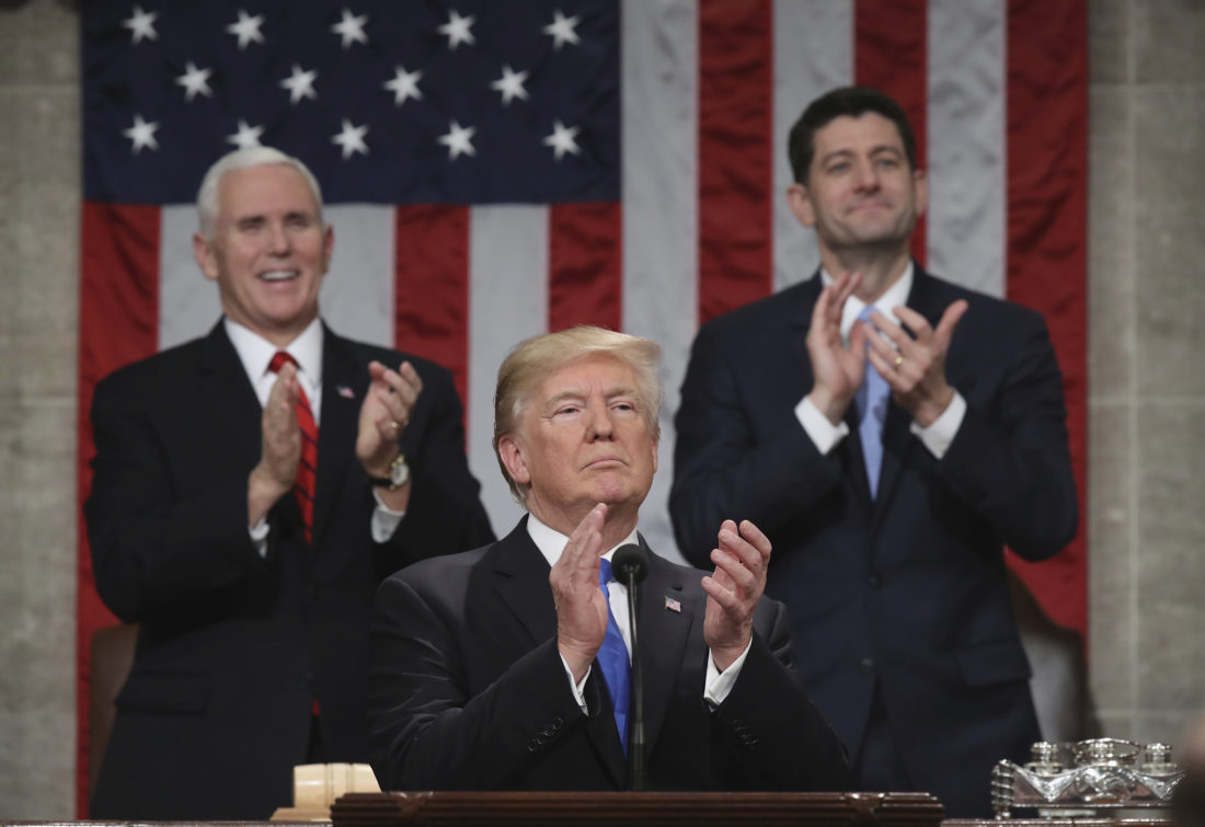 President Donald Trump pauses as he gives his first State of the Union address in the House chamber of the U.S. Capitol to a joint session of Congress Tuesday, Jan. 30, 2018 in Washington, as Vice President Mike Pence and House Speaker Paul Ryan applaud. (Win McNamee/Pool via AP)