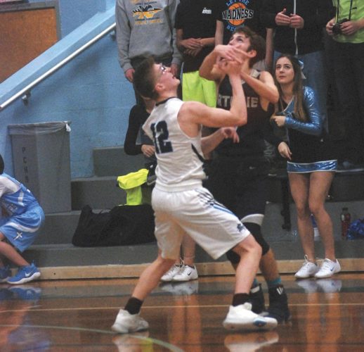 Parkersburg Catholic’s Cade Ullman fights for the basketball during the Crusaders’ 81-47 win over Ritchie County Tuesday night. 
Photo by Steve Hemmelgarn