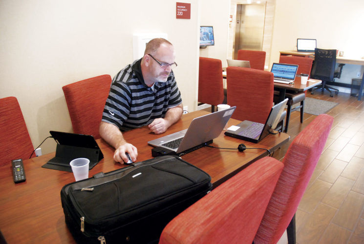 Photo by Evan Bevins
Christopher Morrow, lead analyst with the Federal Reserve Bank of St. Louis, takes advantage of the Internet access at the TownePlace Suites by Marriott on Seventh Street in Parkersburg Wednesday. Morrow is lodging at the recently opened extended-stay facility while in town for business at the Bureau of the Fiscal Service.