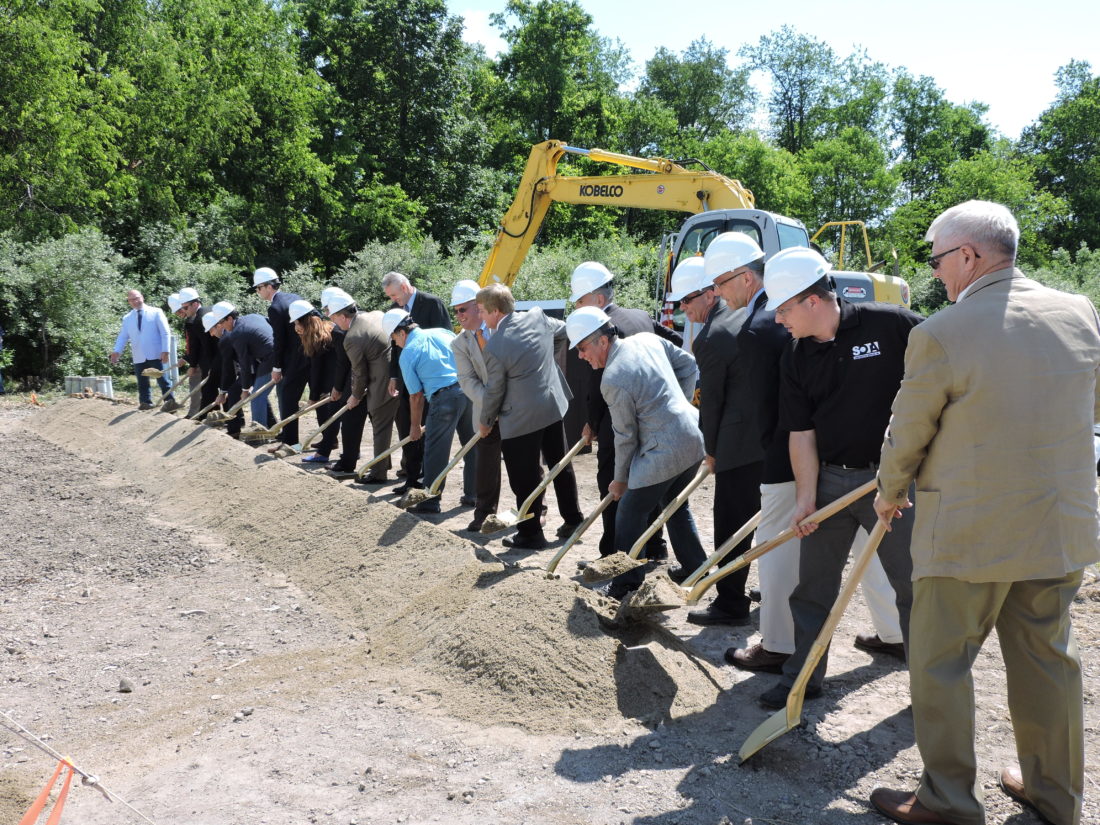 Local and state government officials, along with representatives of Pietro Fiorentini, area development officials and other guests take part in a ceremonial groundbreaking Friday for the company's new Weirton operations. The $5.5 million facility will be located in the Three Springs Business Park. The shovels used in the ceremony were produced by Bully Tools, of Wintersville. -- Craig Howell