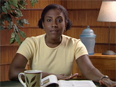 mom sitting at desk with notebook
