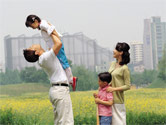 mom, dad and two kids in park