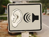 sign with ear listening to sound waves