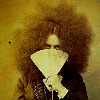 Vintage photo of a crazy-haired lady with a fan.