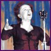 Edith Piaf at the microphone, arms flung wide.