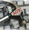 A hammer with the letters "AO3" on top of a keyboard with keys knocked loose.