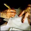 a pair of hands, writing