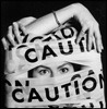 woman wrapped in caution tape