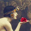 profile of a woman holding a red rose in her hand