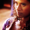 Gwen looking intense w/ her face partly in shadow