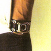 photo of wrist with watch, yellow background