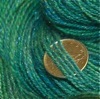 Close-up of handspun yarn with dime for scale