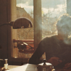 Writer at desk with smoky foreground.