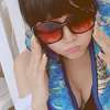a girl wearing sunglasses and pursing her lips