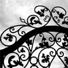 a wrought iron gate silhouetted against the sky