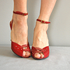 model wearing vintage red leather heels