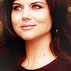 Tiffani Thiessen as Elizabeth Burke, smiling