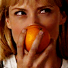Parker from Leverage smiling behind an orange