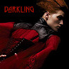 The red moon in the dark room. Dark walls. Dark houses. Dark corners.  She's dark herself