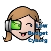 cartoony face with cyborg eye implant and the text "Low Budget Cyborg"